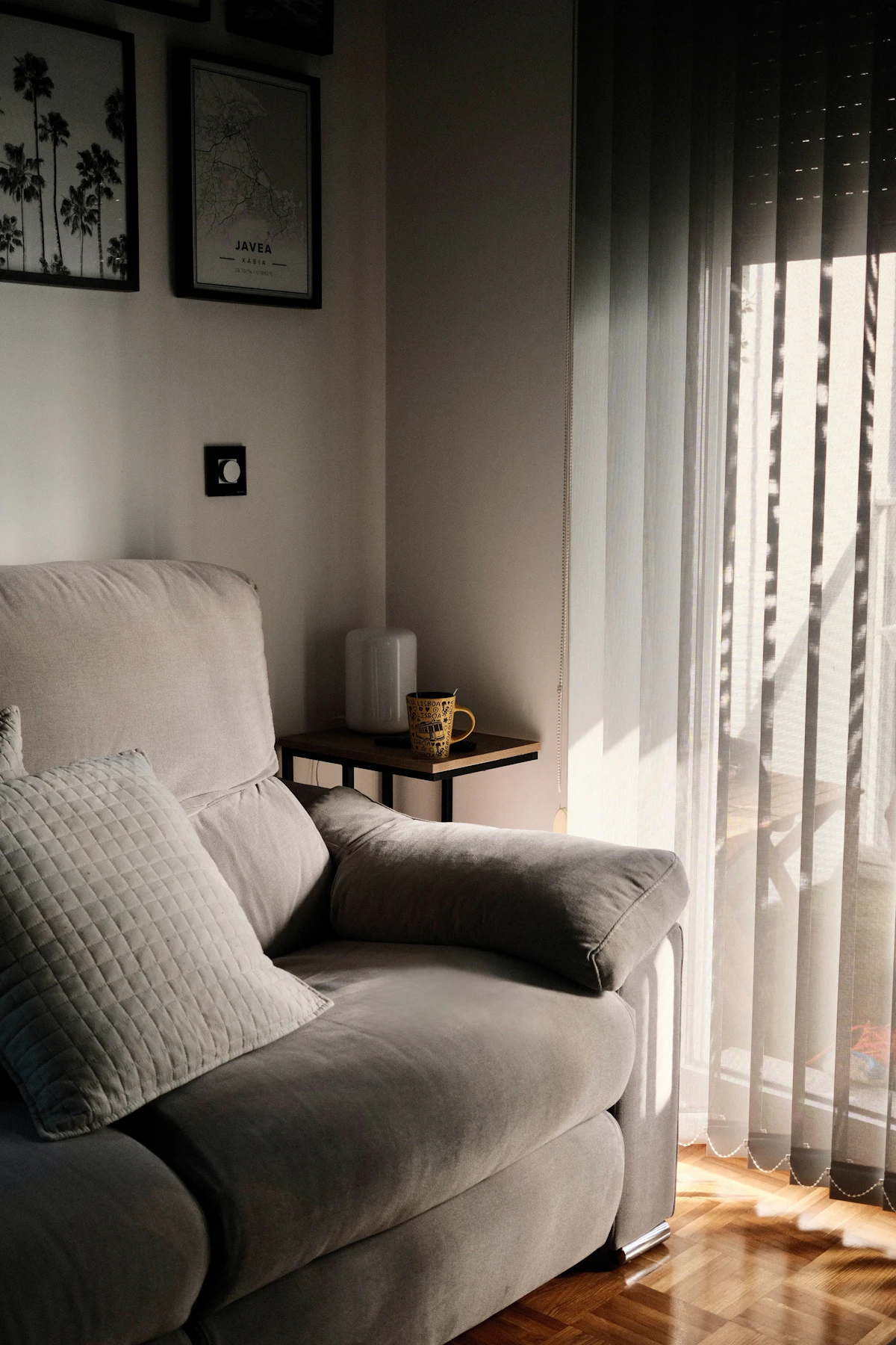 A quiet corner at home, with sunlight falling across a sofa and a coffee mug.
